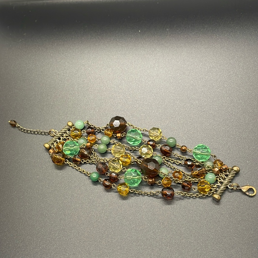 Multi-strand Lia Sophia chunky bracelet, crystal beads-green, brown, amber tones